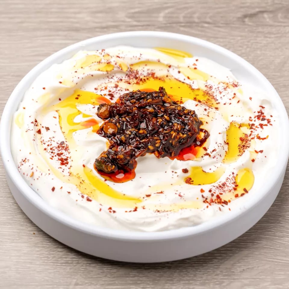 Creamy white dip topped with dark chili oil, golden olive oil, and red pepper flakes.